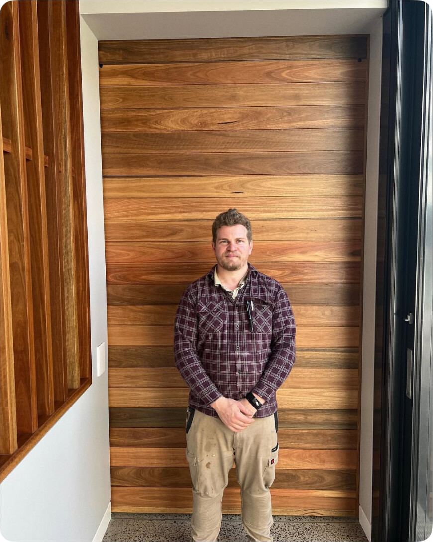 Aaron Crouch of A.J. Custom in front of a custom timber door